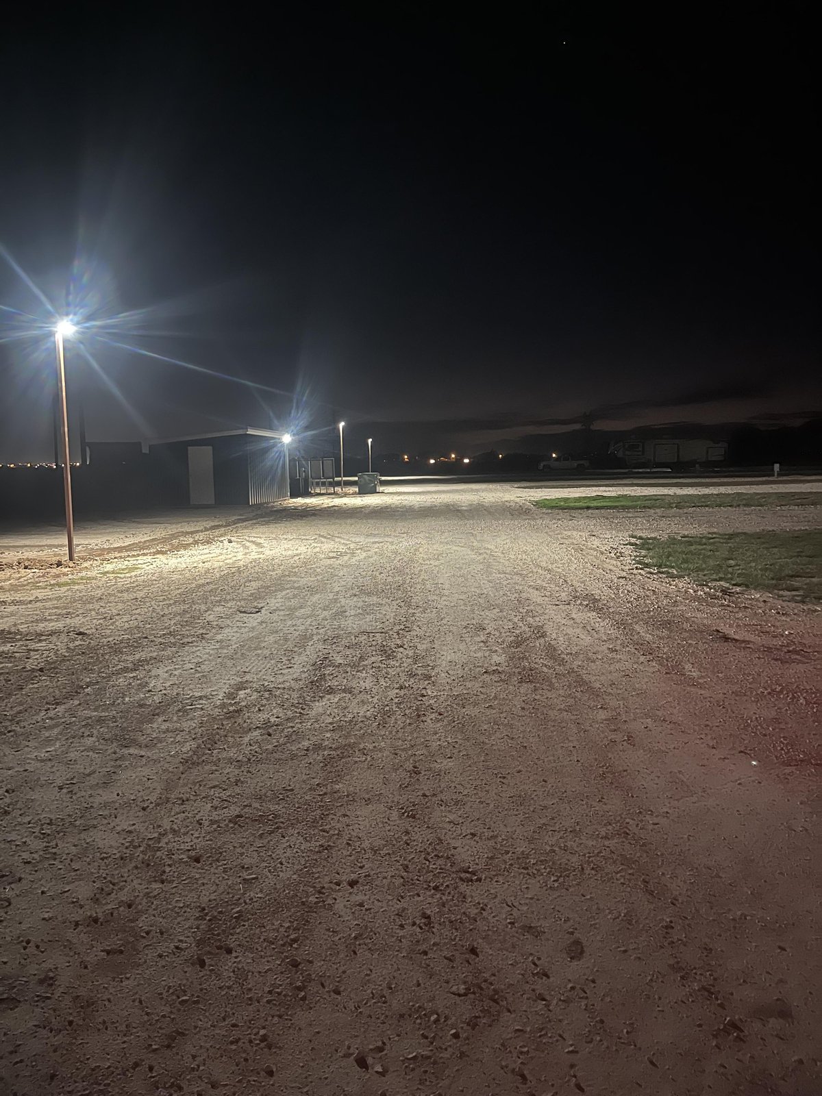 A night shot of the RV park with the lights on.